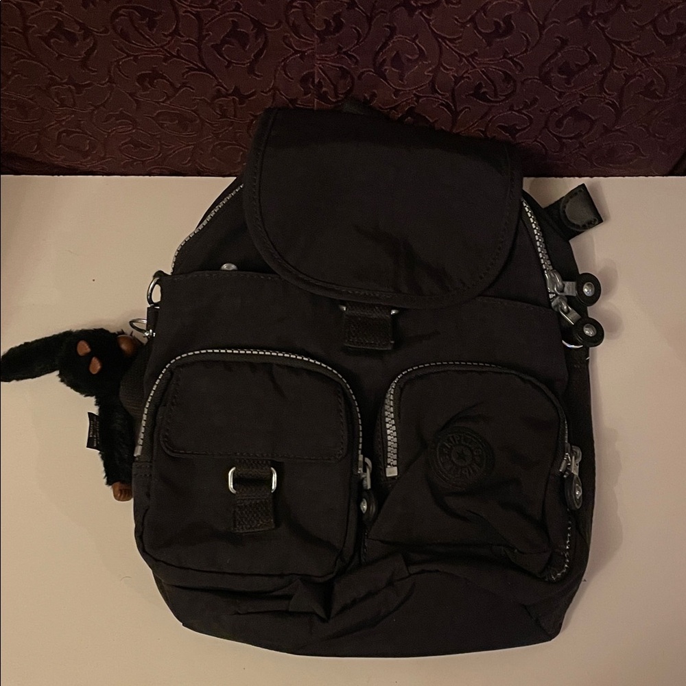 Kipling Black Mini Backpack with monkey keychain LENGTH 12”
WIDTH 10 1/2”.